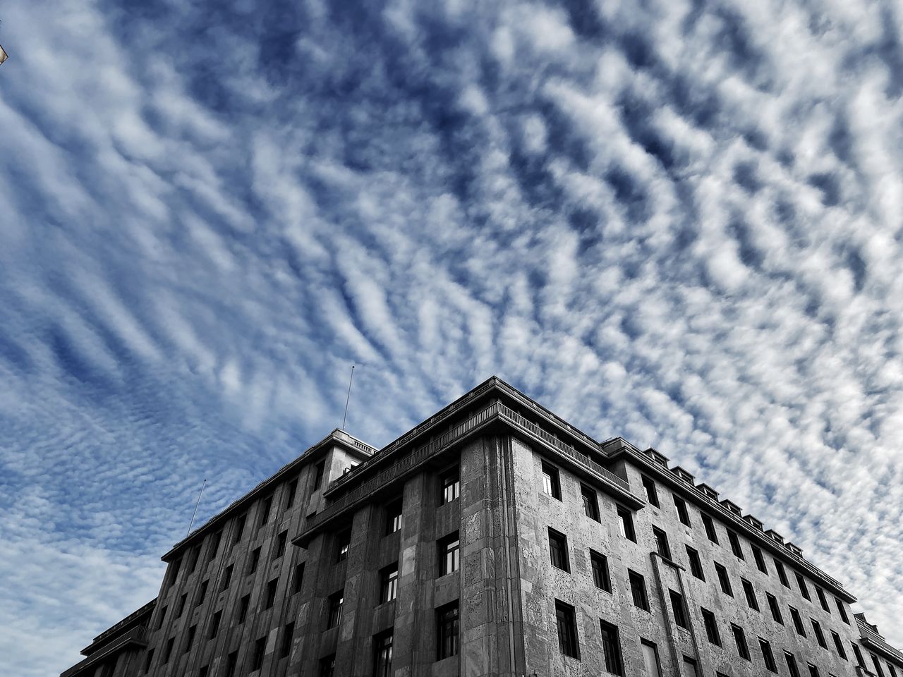 Low angle view of building against cloudy sky