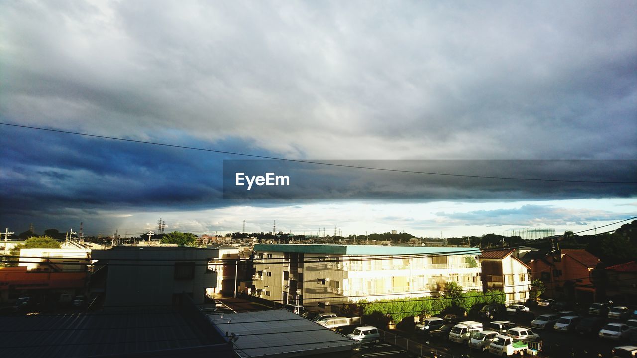 VIEW OF BUILDINGS AGAINST CLOUDY SKY