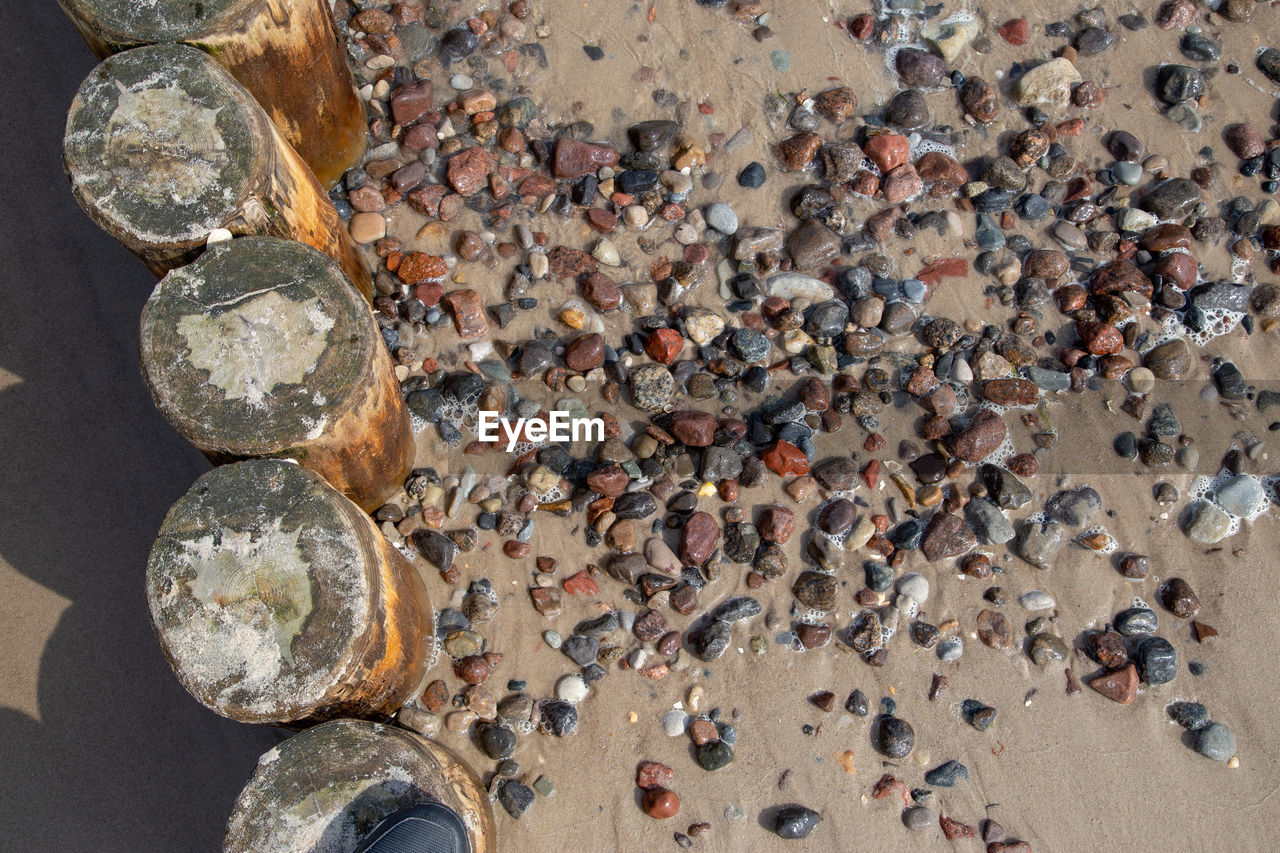 High angle view of pebble stones at beach