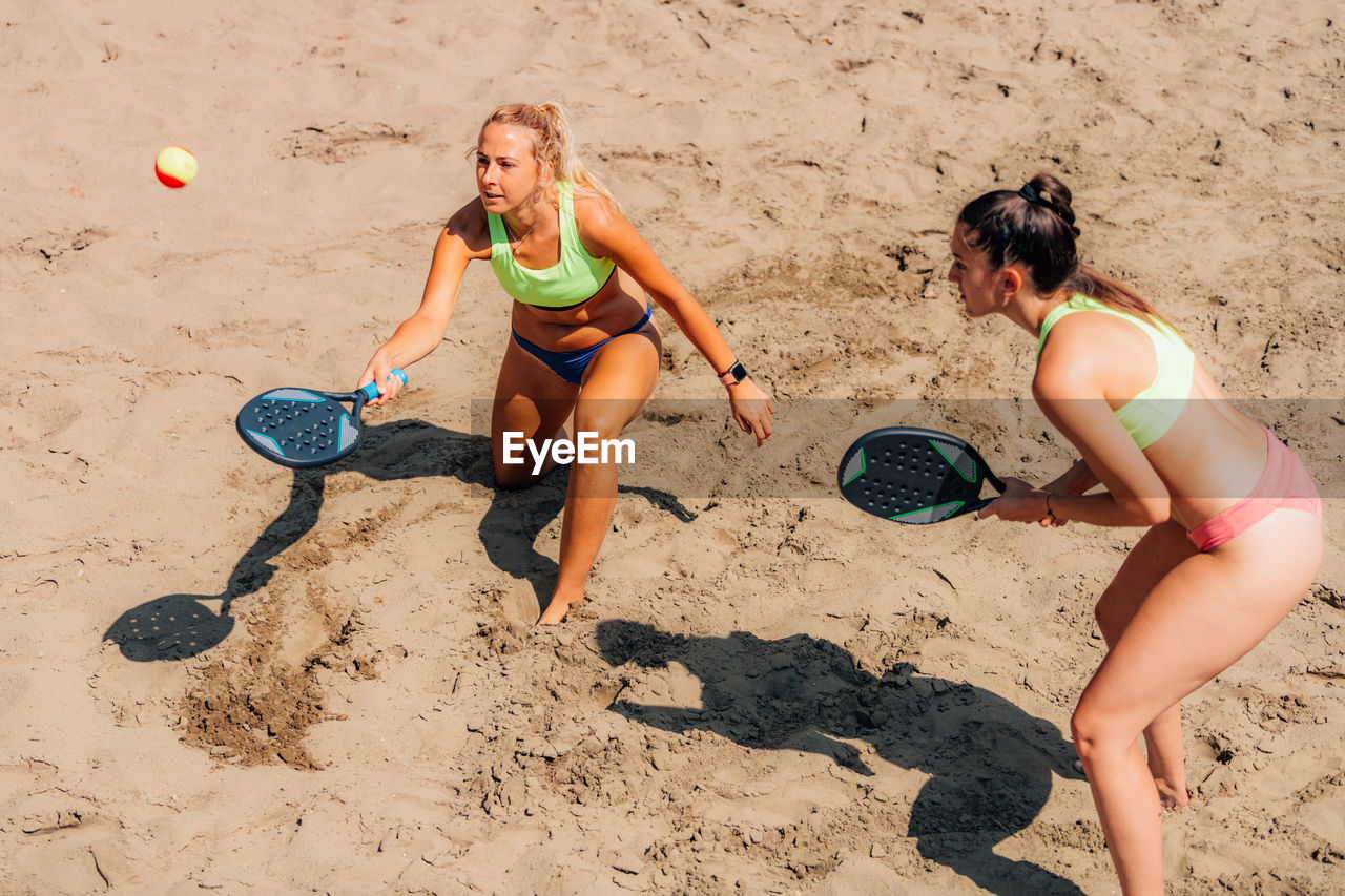 Female team playing beach tennis
