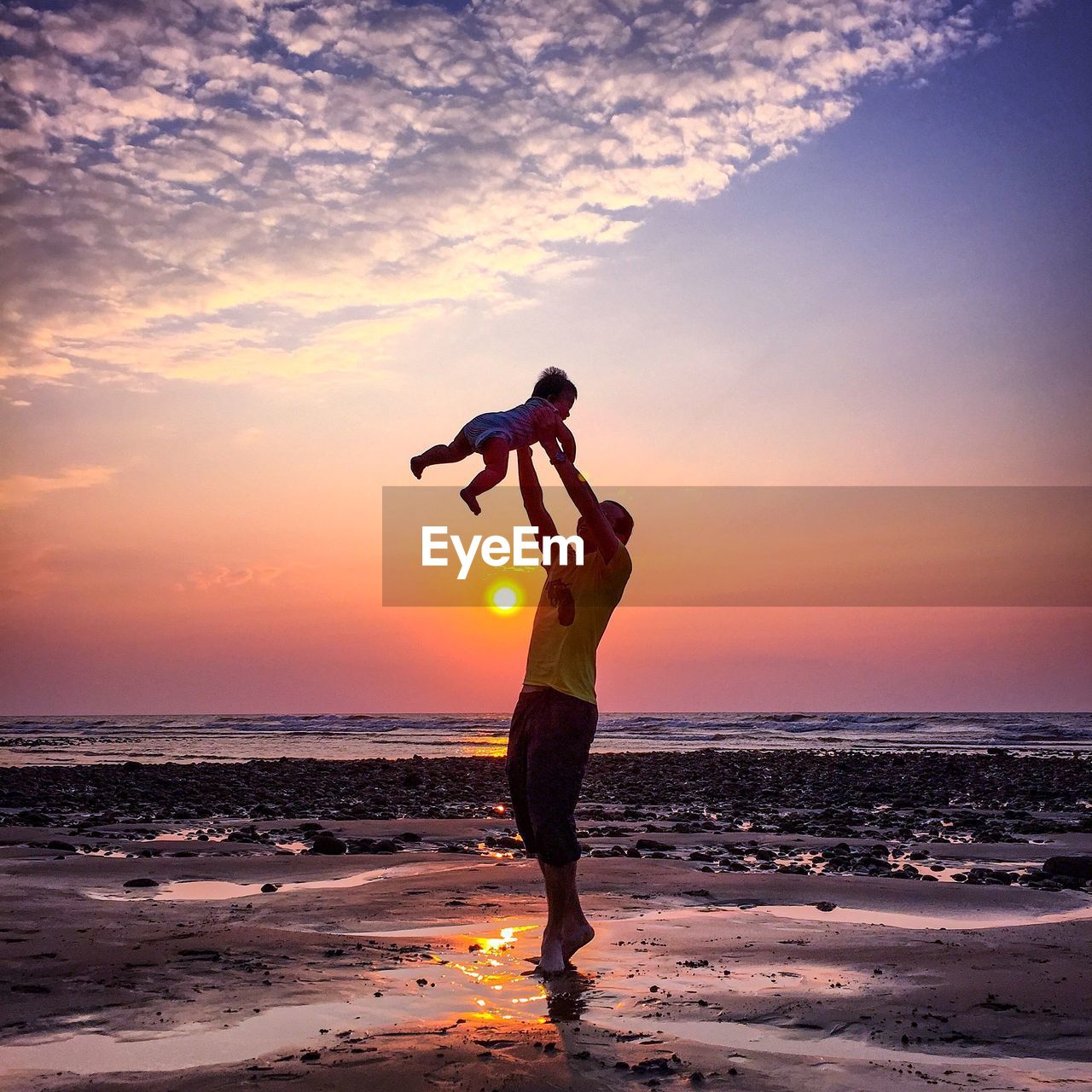 Full length of man standing at beach during sunset