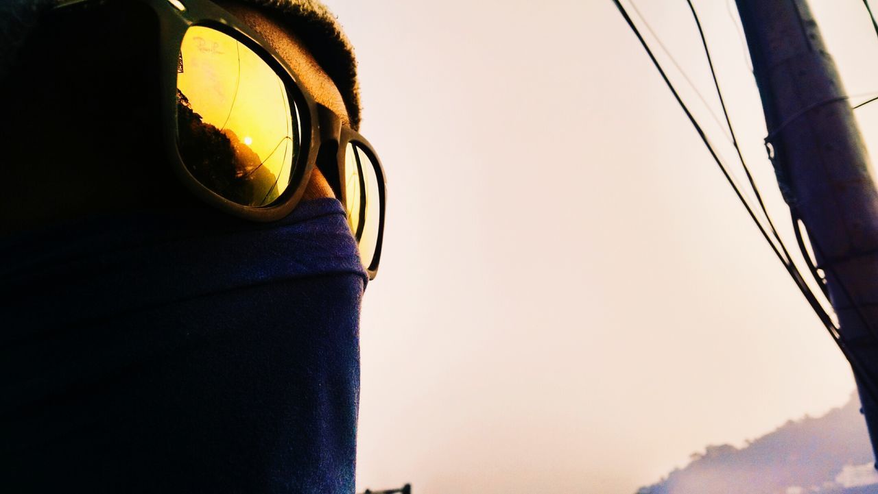 Cropped image of man wearing scarf and sunglasses