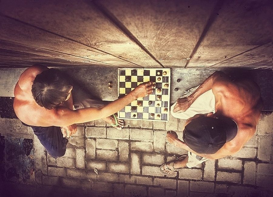 Directly above shot of men playing chess outdoors