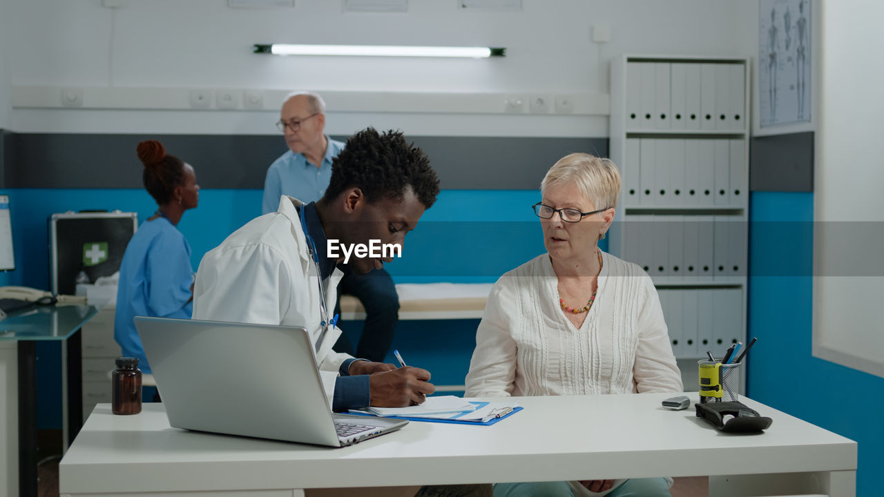 People working on table in office