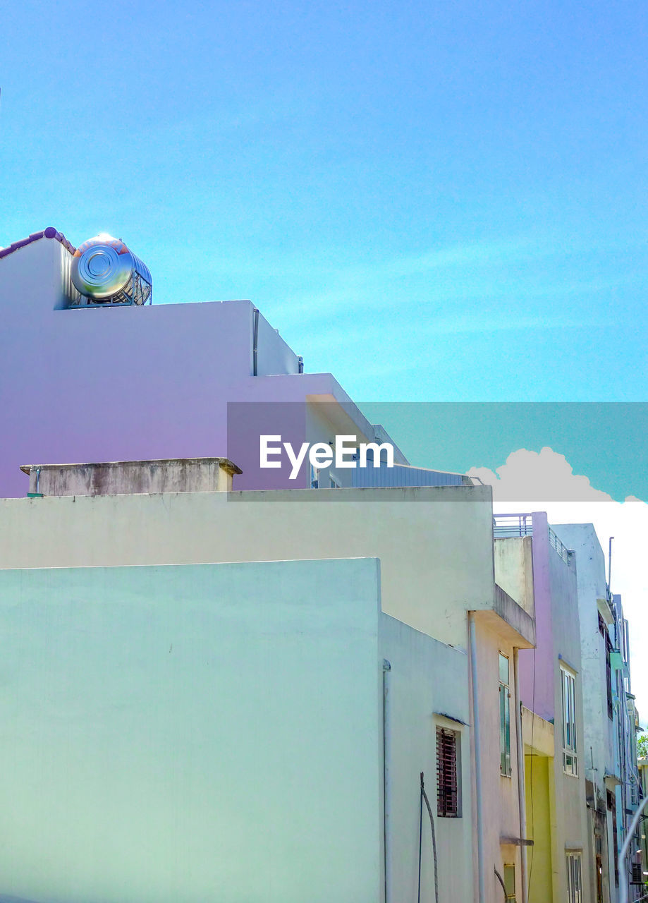 Low angle view of buildings against blue sky