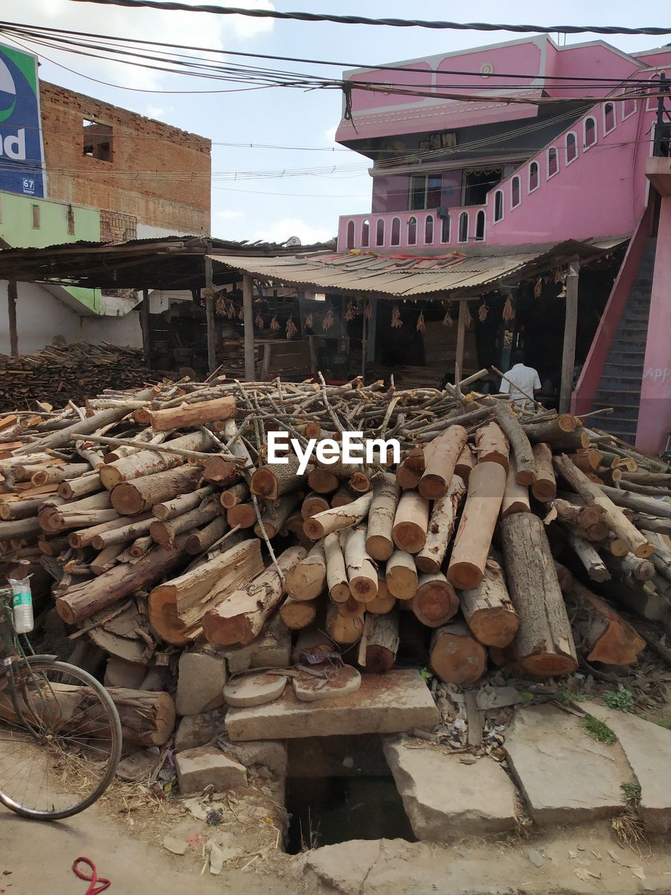 STACK OF LOGS ON BUILDING