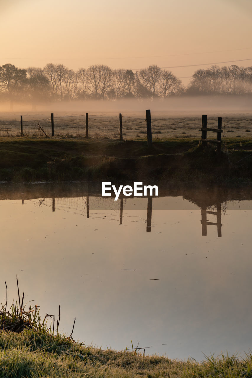 Scenic view of lake against sky during sunset