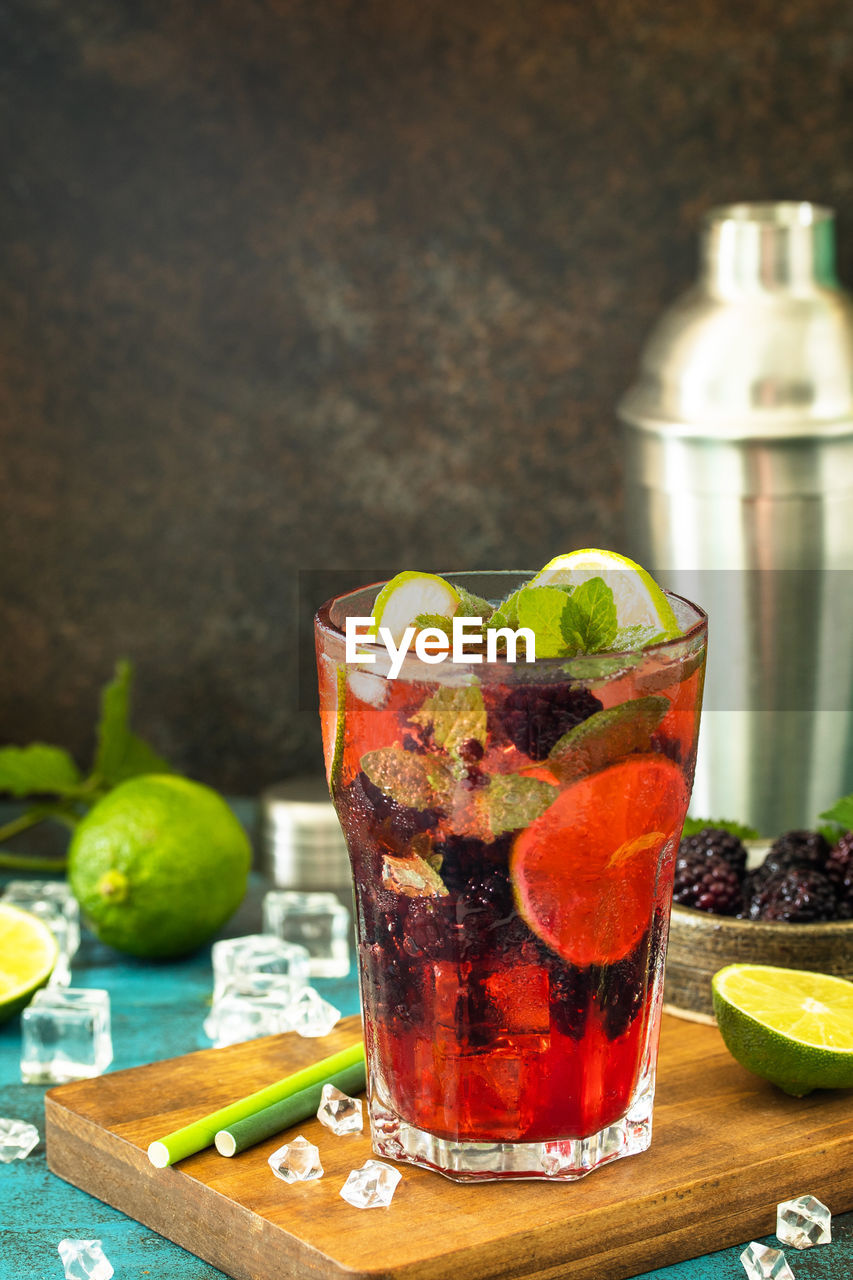 Summer refreshing drink with blackberry, mint, lime and ice, mojito or blackberry soda. 