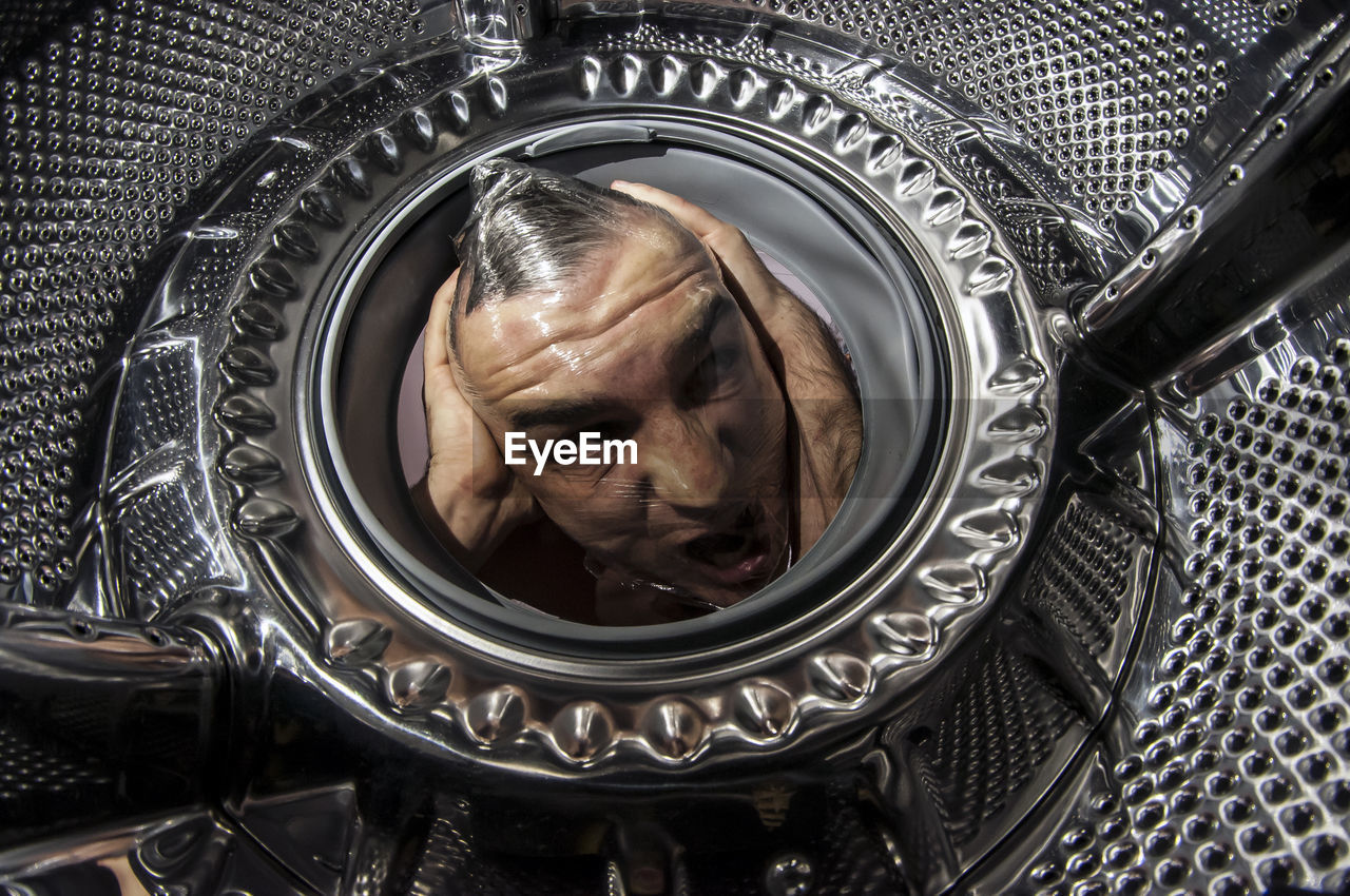 CLOSE-UP PORTRAIT OF WOMAN WITH REFLECTION OF METAL