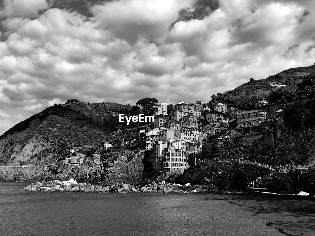 PANORAMIC VIEW OF RESIDENTIAL DISTRICT AGAINST CLOUDY SKY