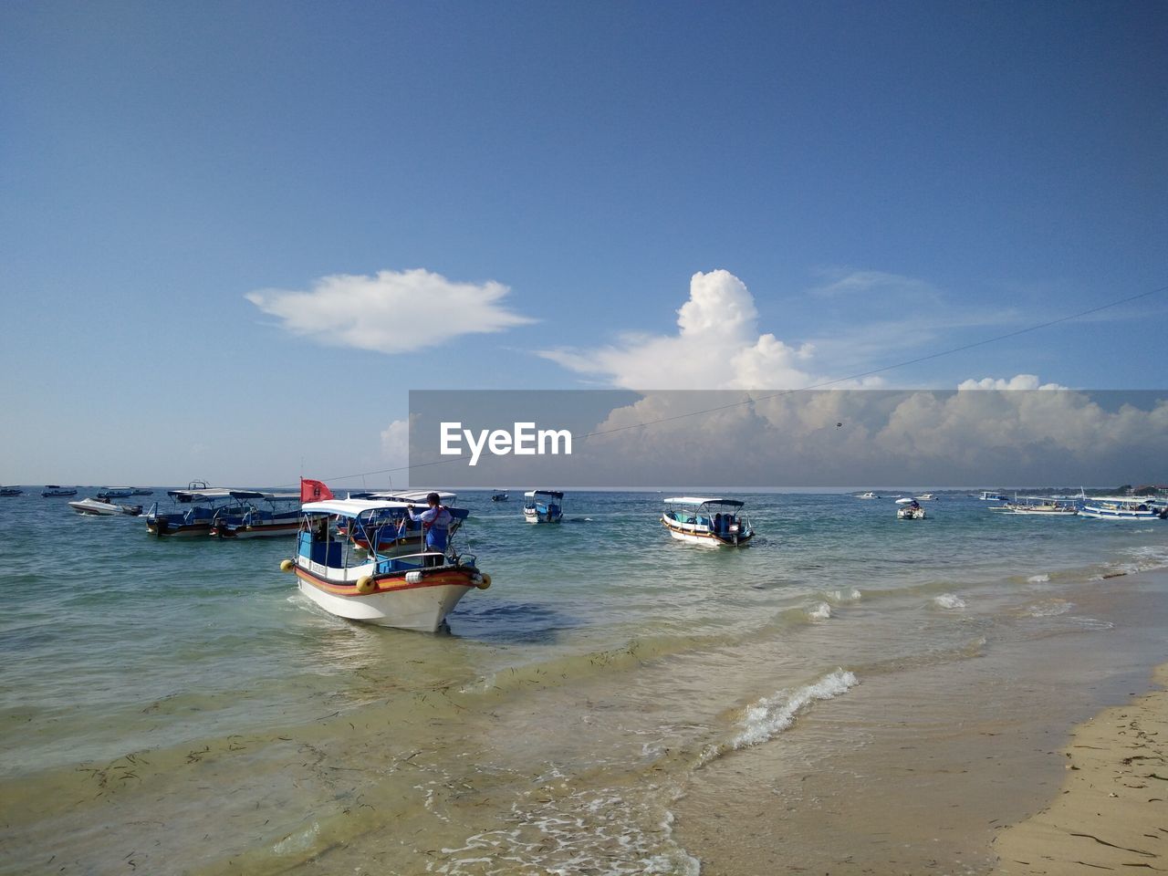 View of boats in calm sea against the sky