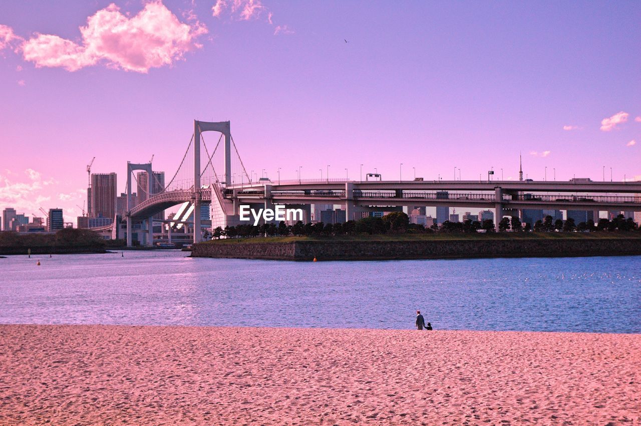 Scenic view of bridge over sea against cloudy sky