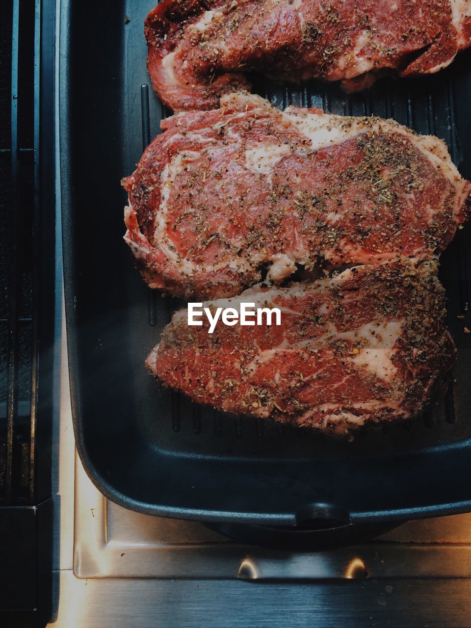 Close-up of meat on frying pan