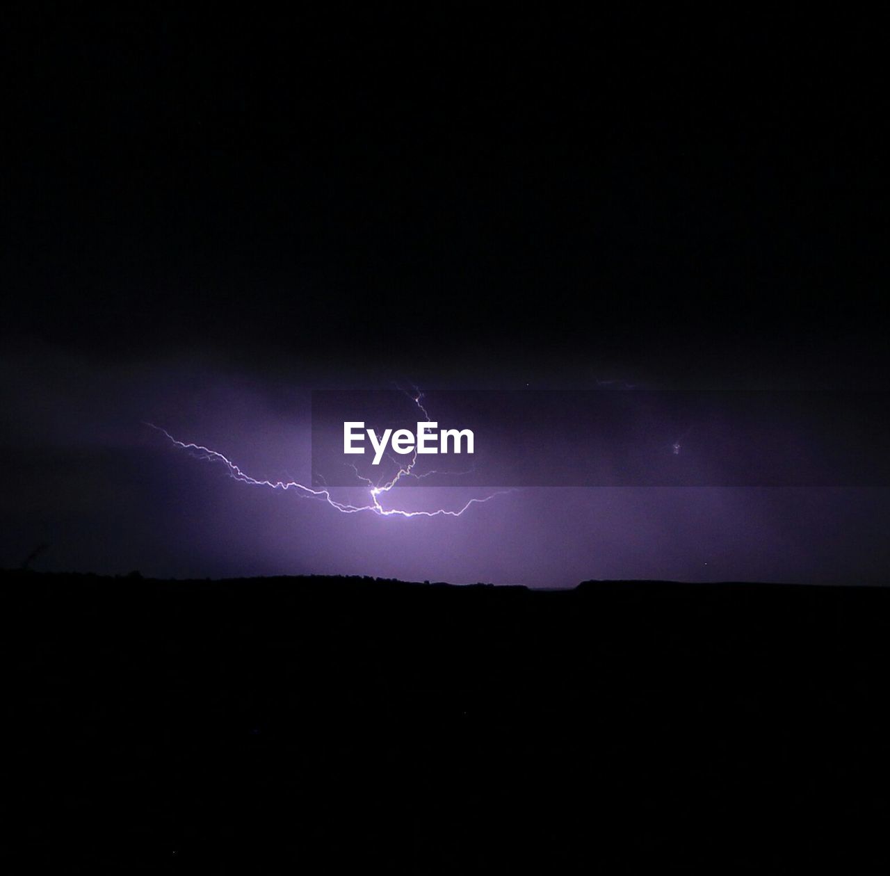 Low angle view of lightning in sky at night