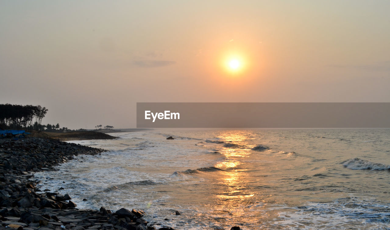 Scenic view of sea against sky at sunset