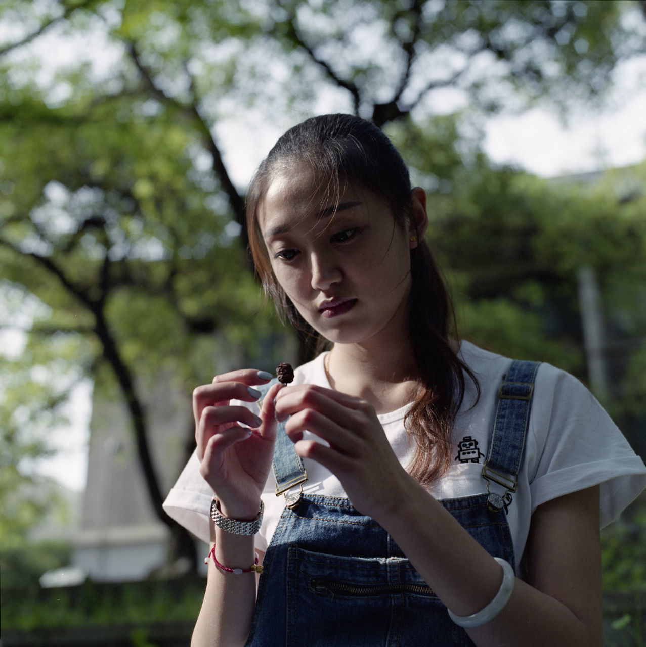 Sad young woman holding dried plant