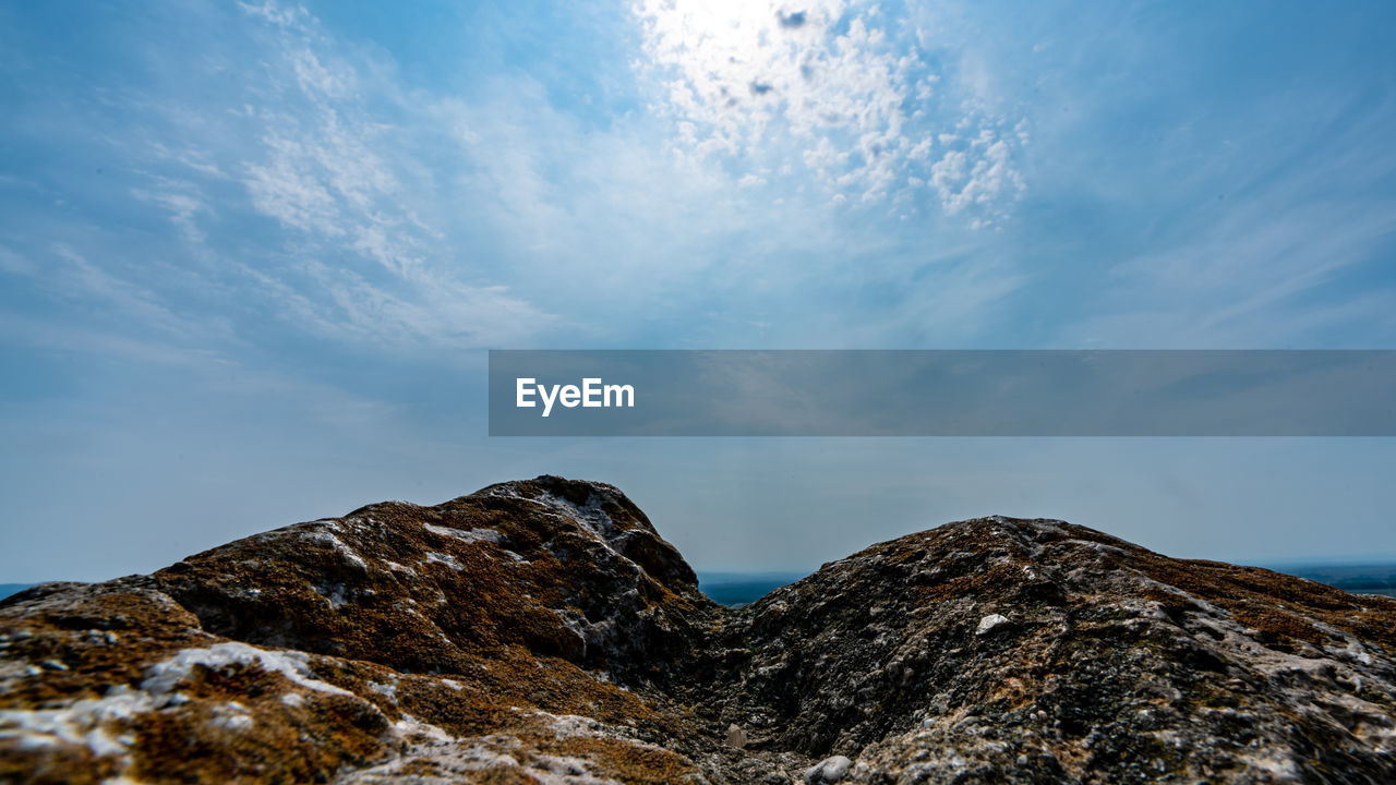 Low angle view of rock formation against sky