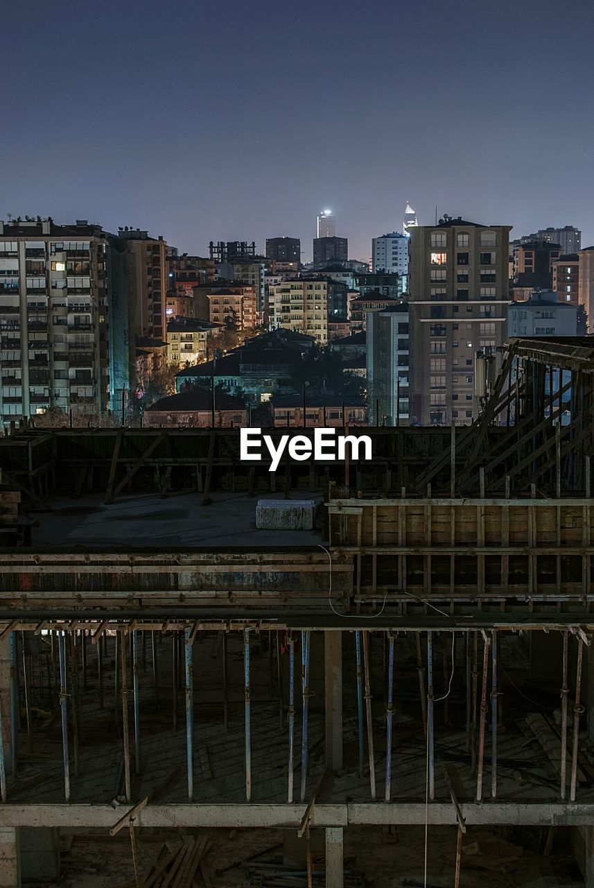 Under construction building in city at dusk