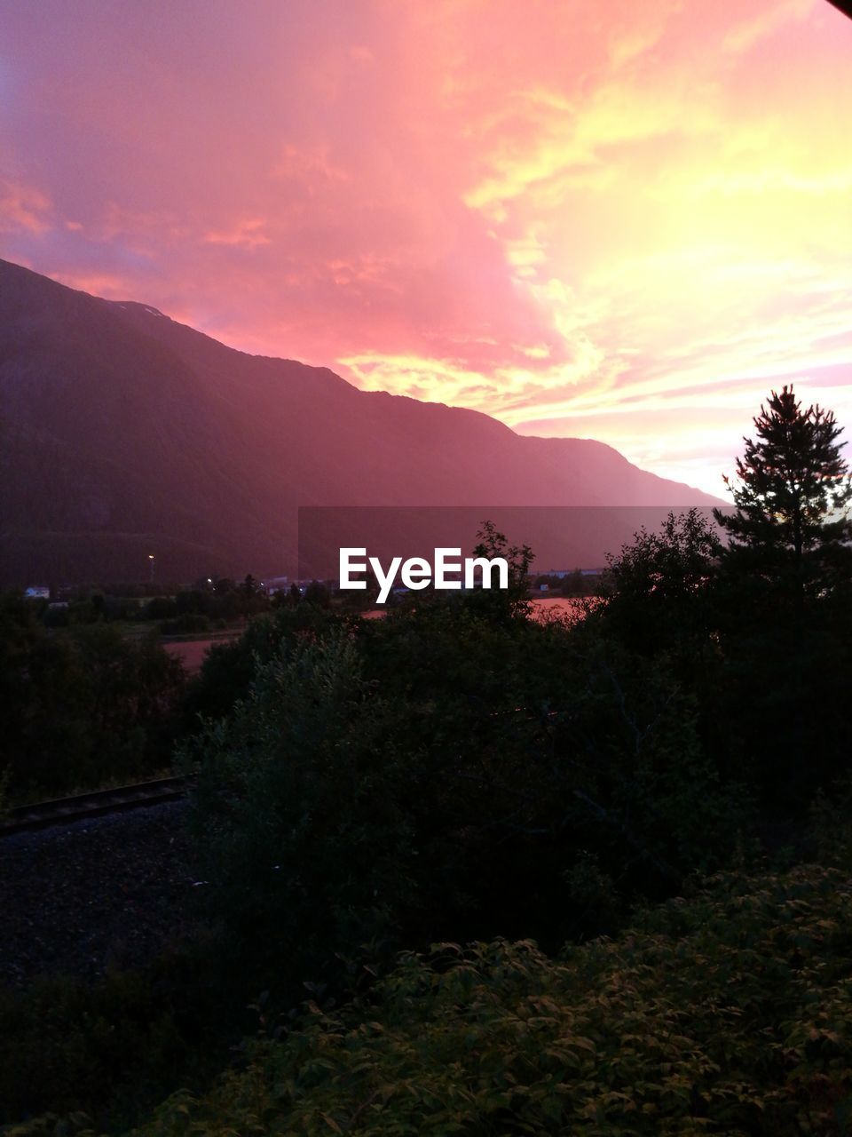 SCENIC VIEW OF MOUNTAINS AT SUNSET