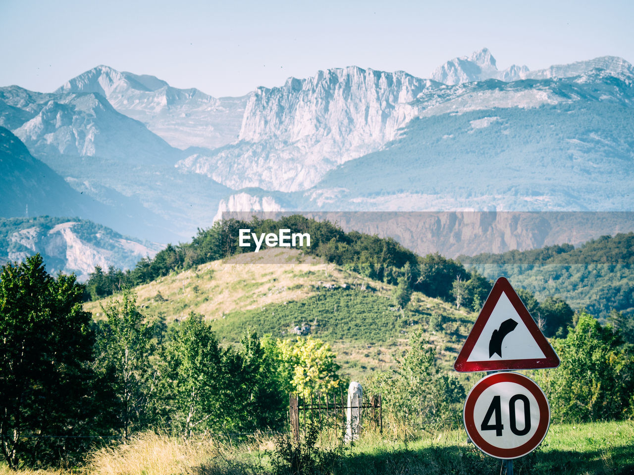 Curve ahead sign entering a mountain region