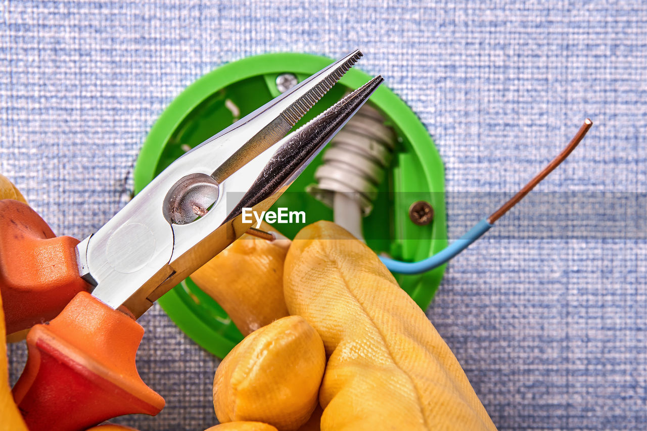 Cropped hands of electrician working on electrical equipment