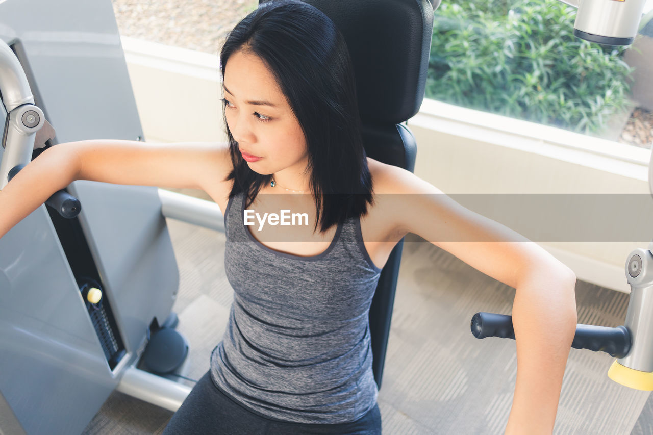 High angle view of woman exercising in gym