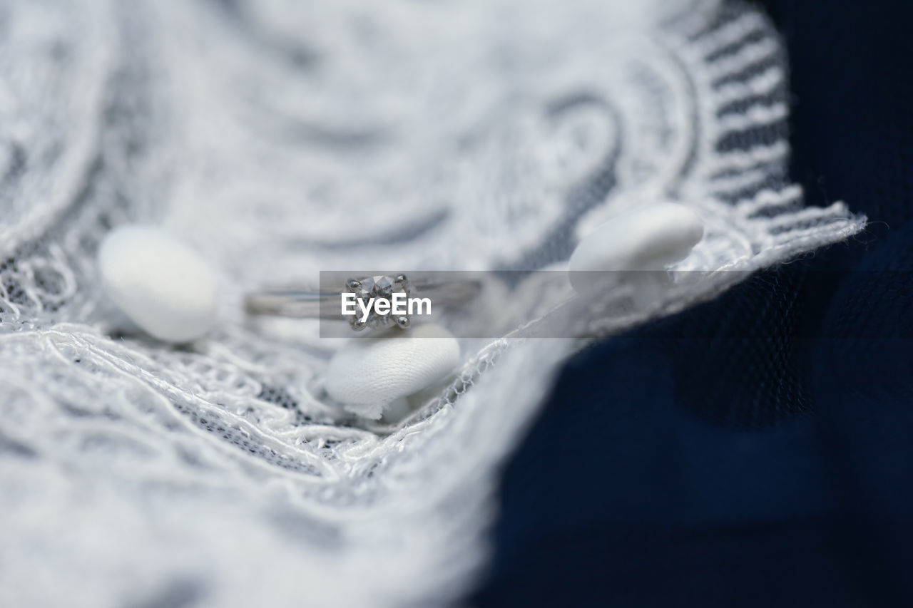 Close-up of wedding ring on fabric