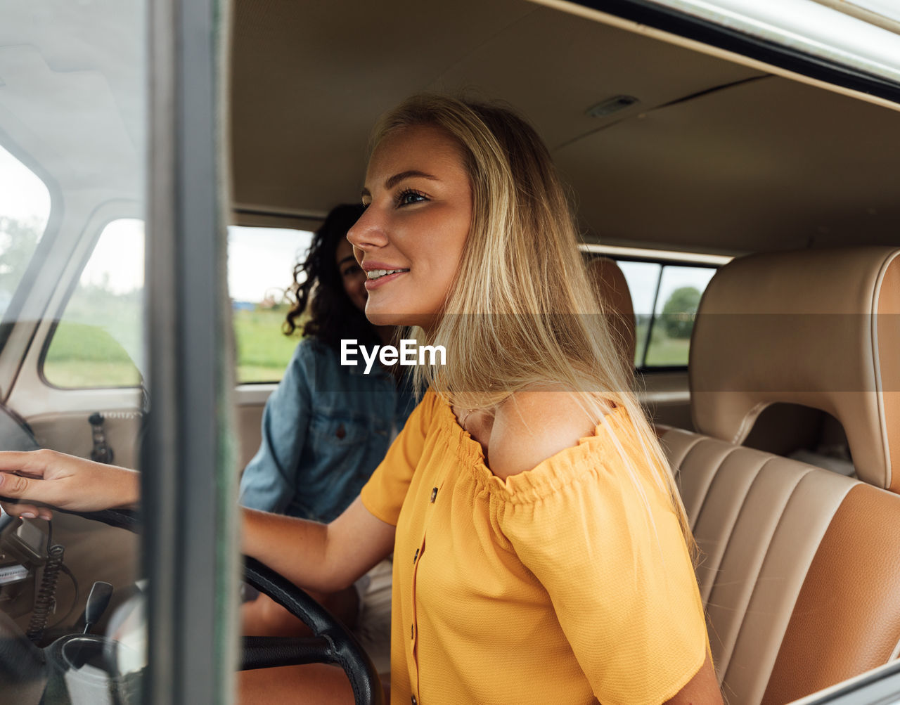 Portrait of smiling young woman in car