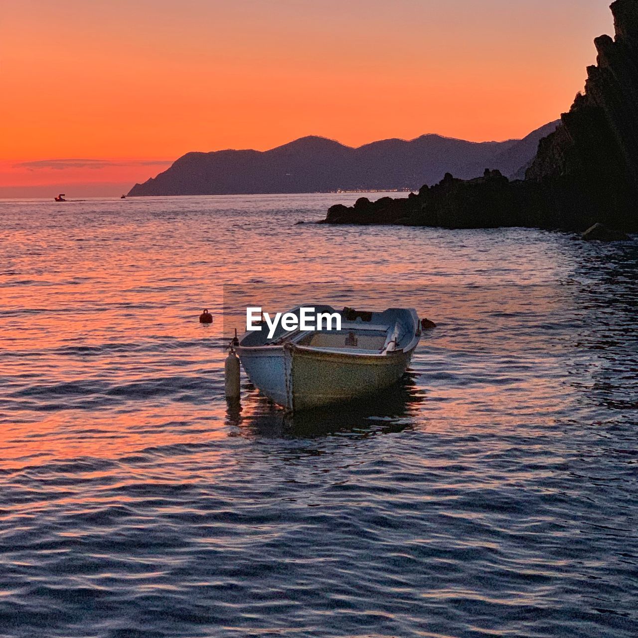 Sunset with boat in foreground at riomaggiore, italy