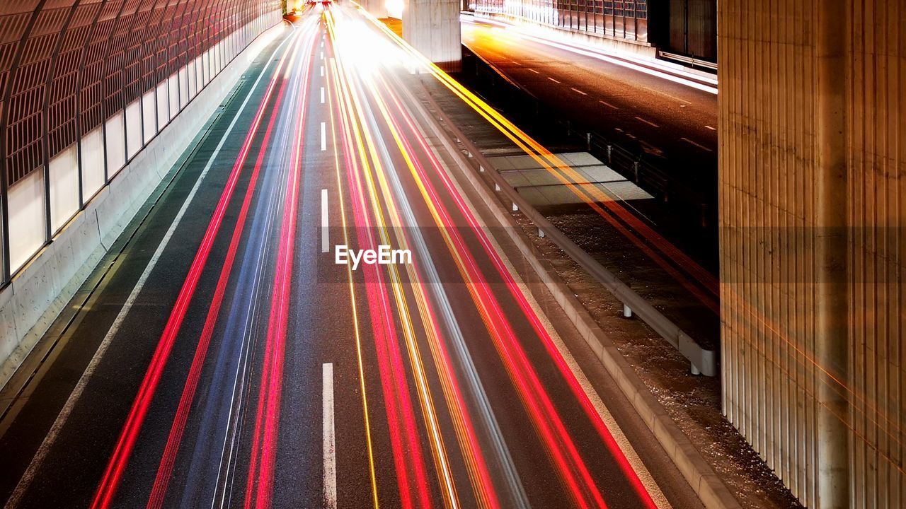 HIGH ANGLE VIEW OF LIGHT TRAIL ON ROAD