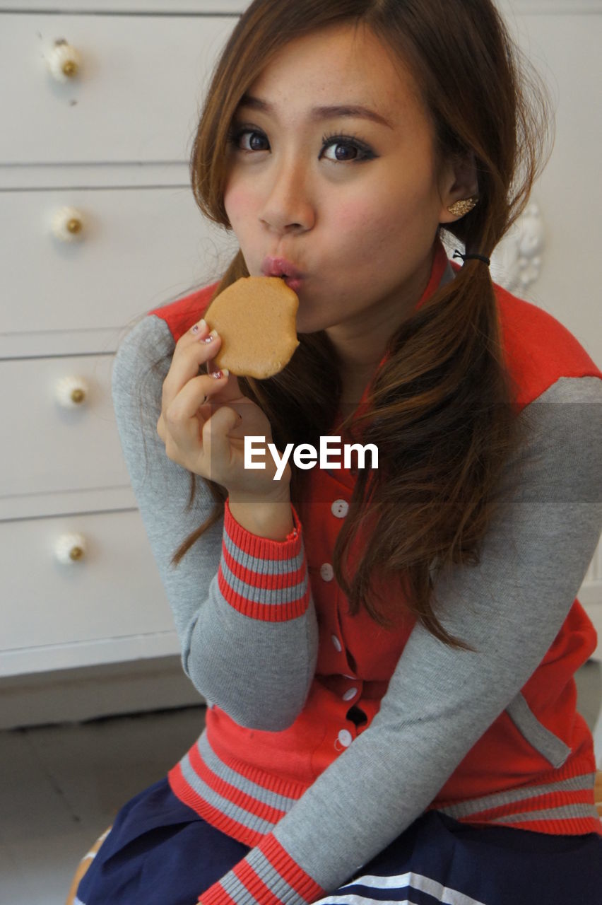 PORTRAIT OF CUTE GIRL EATING ICE CREAM