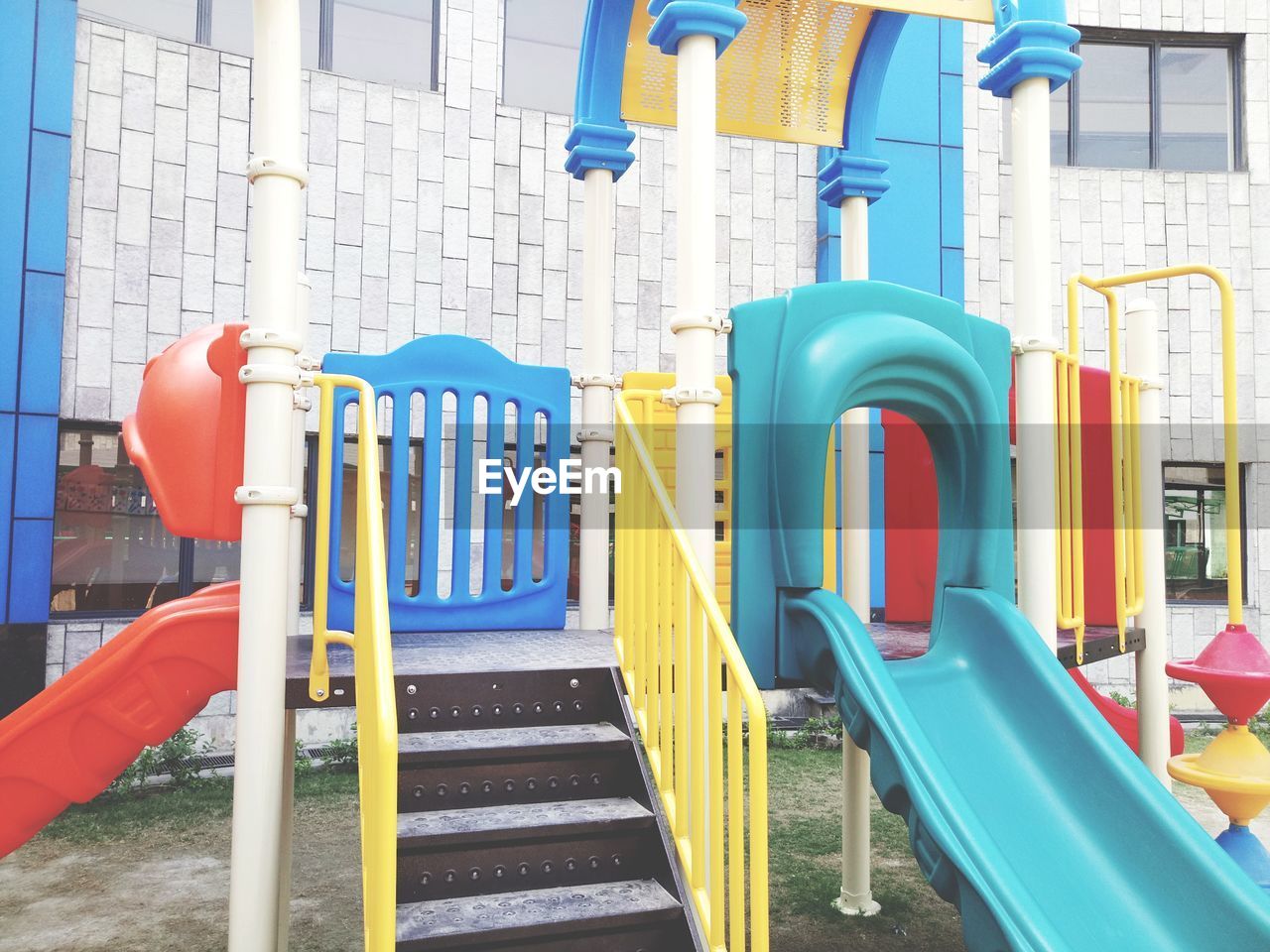 CLOSE-UP OF MULTI COLORED PLAYGROUND IN BLUE WATER