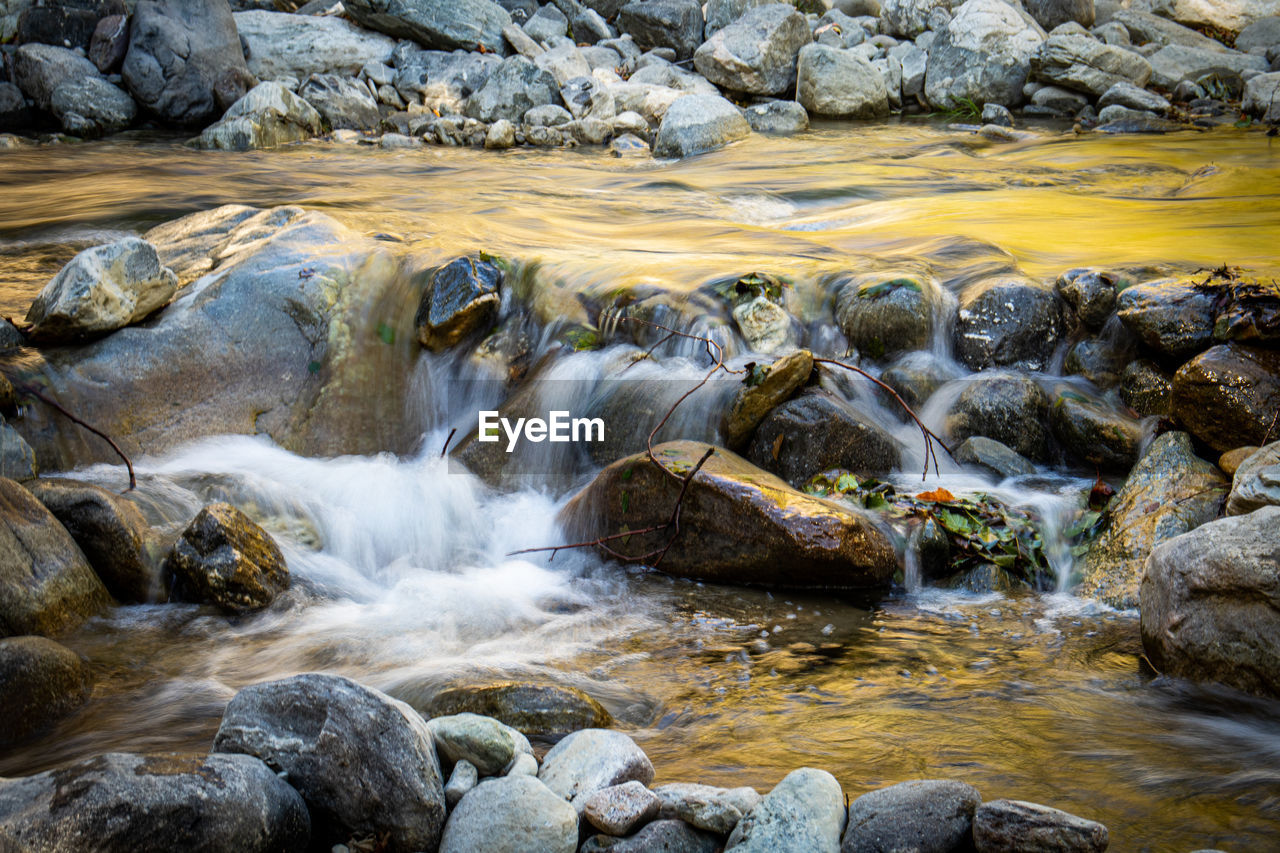 Stream flowing through rocks in sea