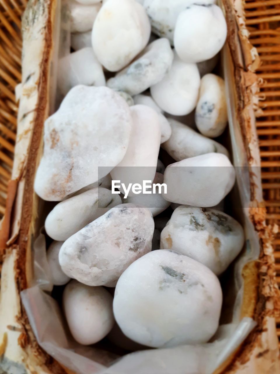 HIGH ANGLE VIEW OF WHITE EGGS IN BASKET