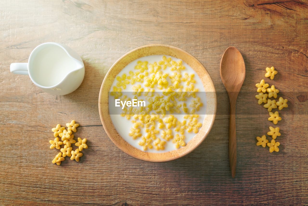 food and drink, food, healthy eating, wellbeing, wood, yellow, freshness, studio shot, bowl, high angle view, indoors, breakfast, produce, kitchen utensil, dairy, no people, refreshment, spoon, tableware, table, eating utensil, drink, dish, breakfast cereal, directly above, seed, snack, milk, ingredient, meal, cereal plant, still life, plant, crockery