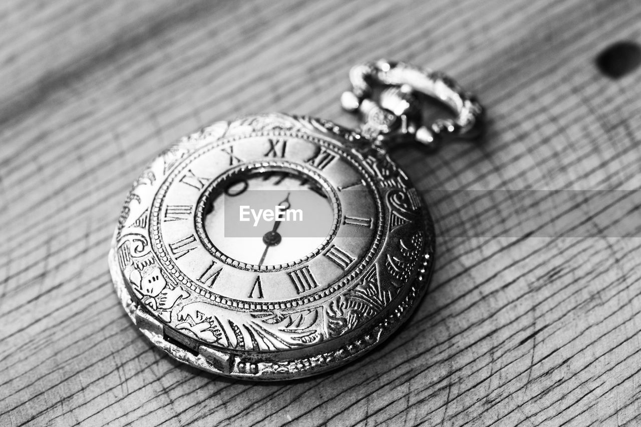 High angle view of old pocket watch on table