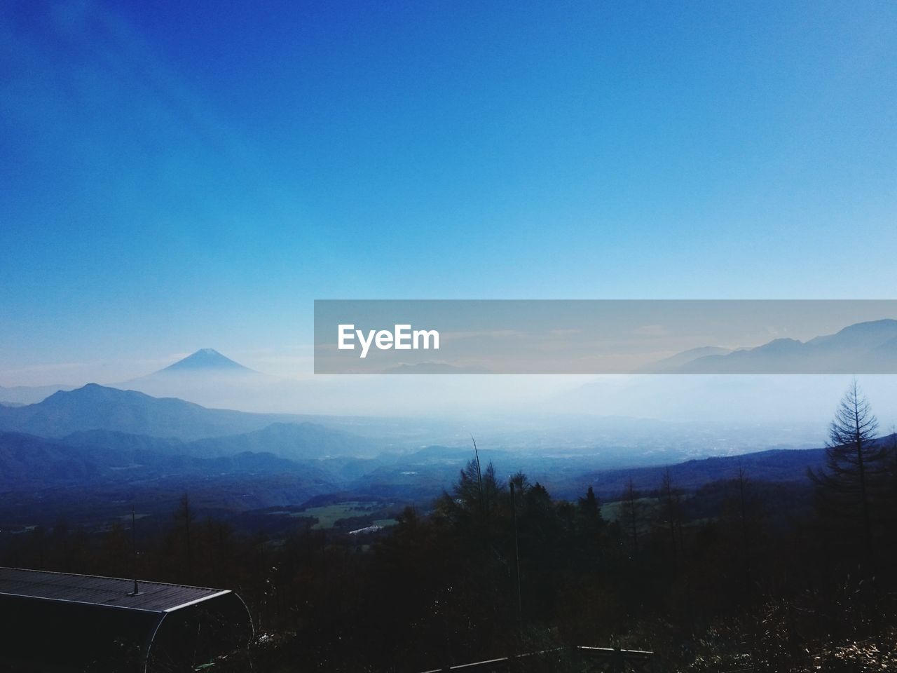 Scenic view of mountains against clear blue sky