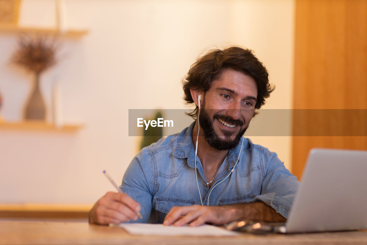 Young business man working with laptop. gray notebook for working. home office . 