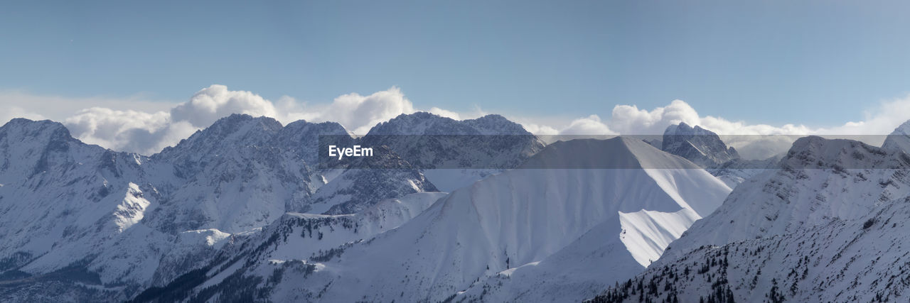 Panoramic view of snowcapped mountains against sky