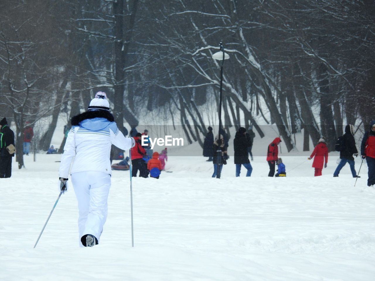 People on snow covered landscape during winter