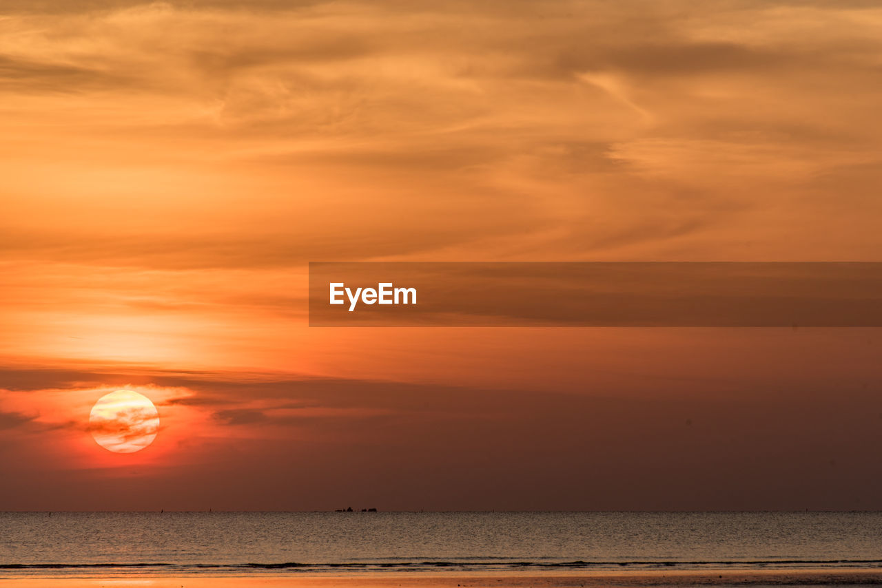 Scenic view of sea against romantic sky at sunset