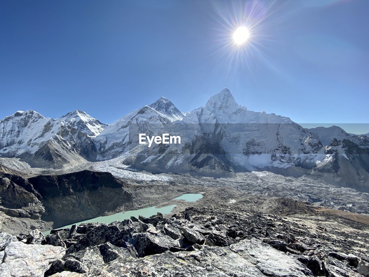 SCENIC VIEW OF SNOWCAPPED MOUNTAINS AGAINST BRIGHT SKY