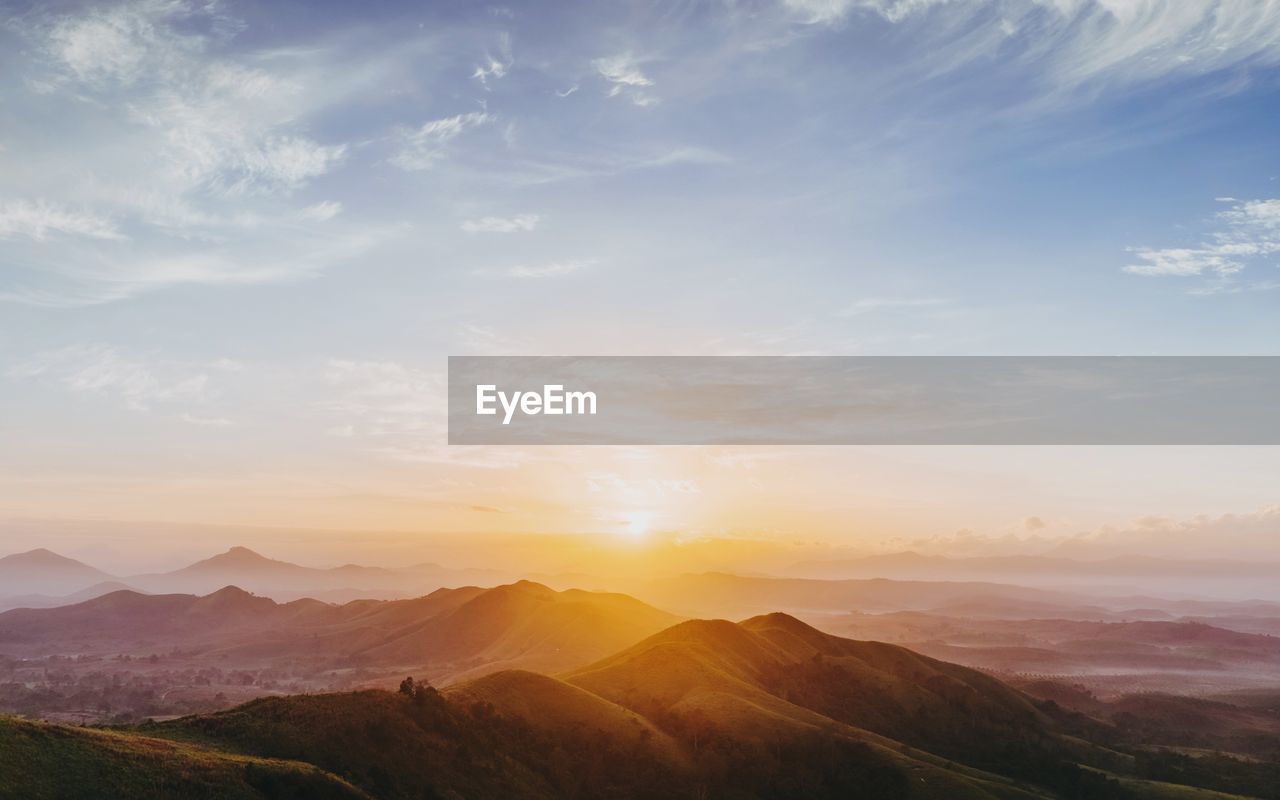 Scenic view of mountains against sky during sunrise