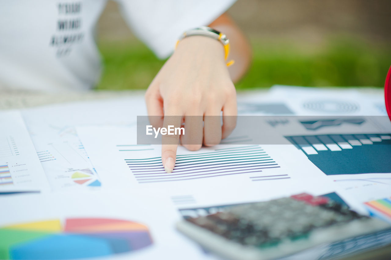 Close-up of businesswoman working at desk in office