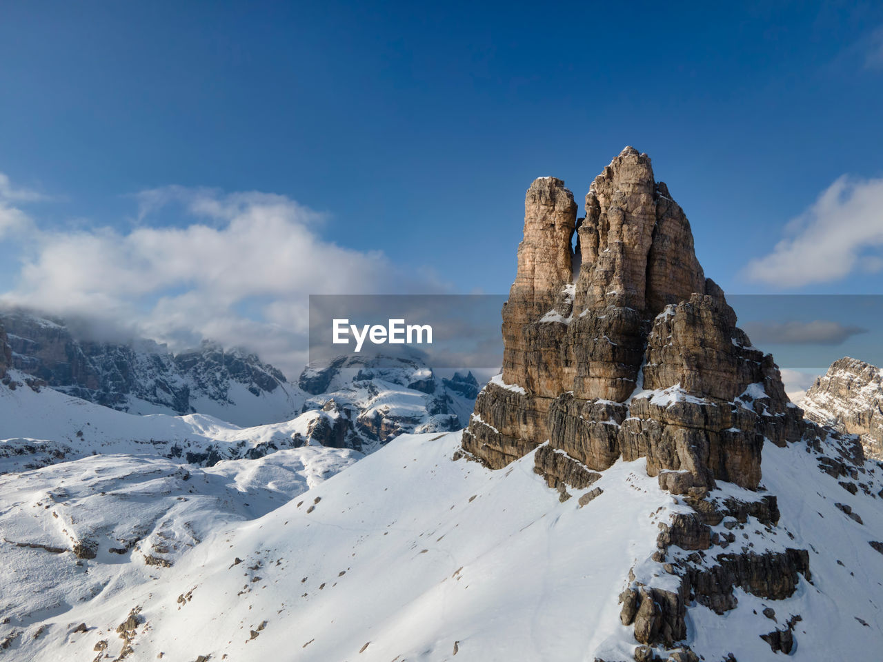 View of snowcapped mountain against cloudy sky