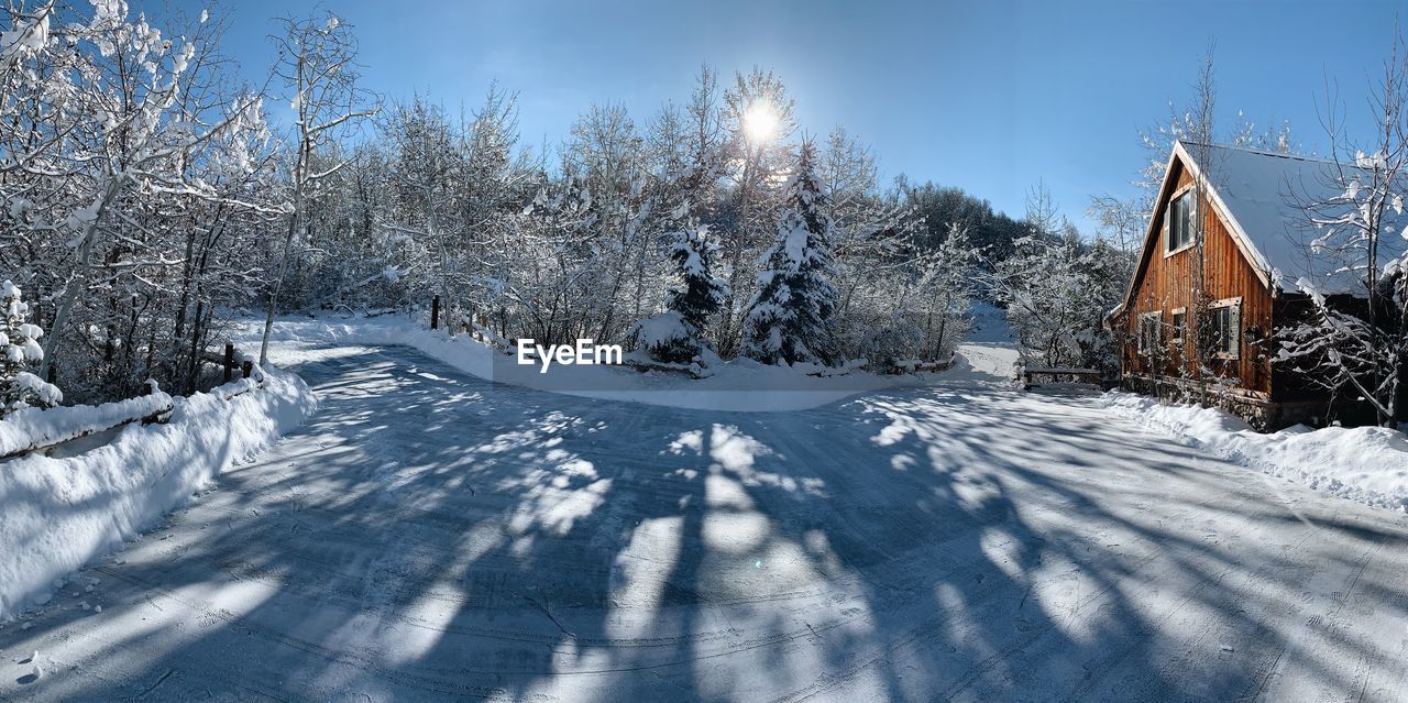 SNOW COVERED LAND AGAINST SKY DURING WINTER