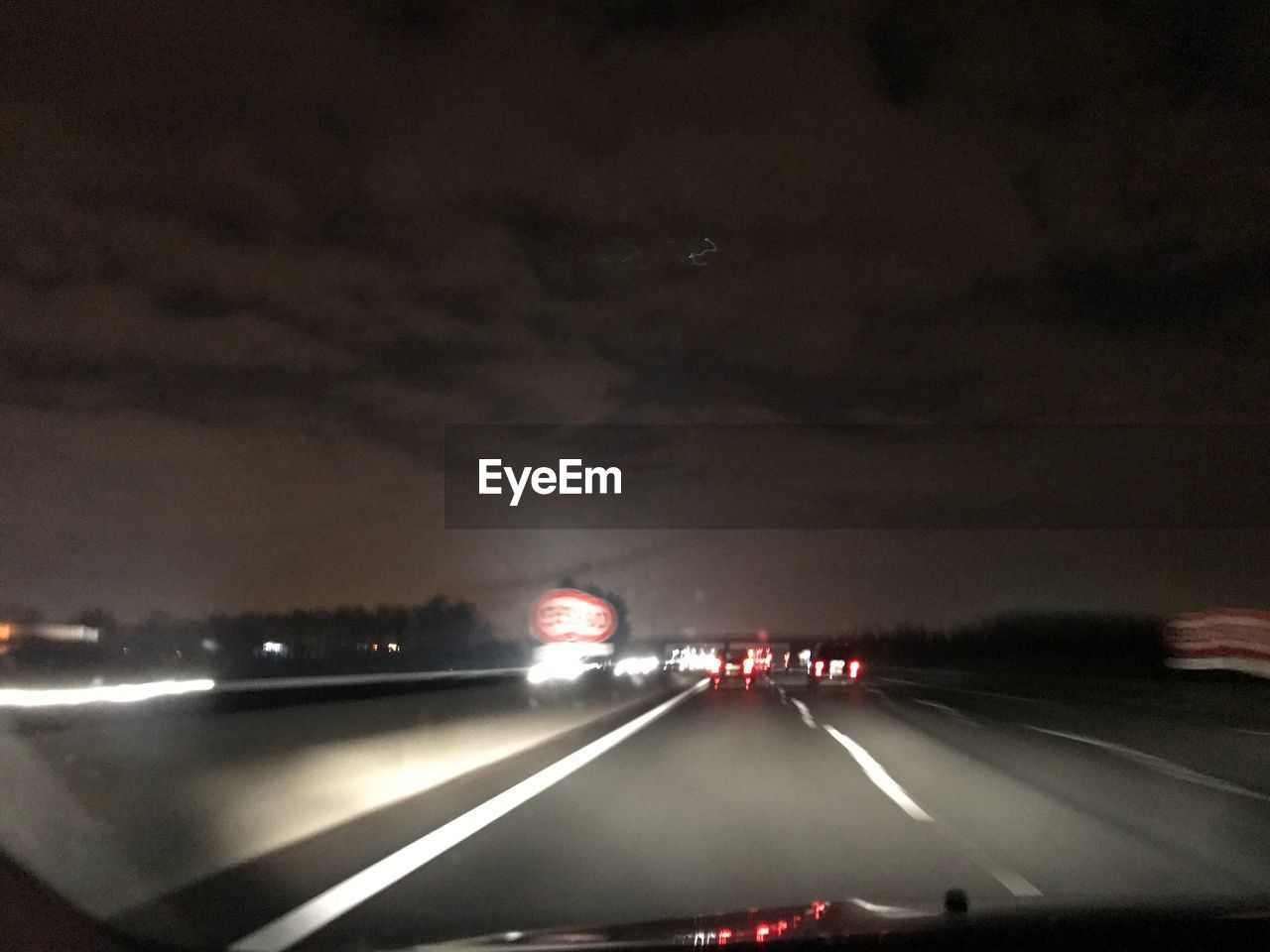 CARS MOVING ON ROAD AT NIGHT