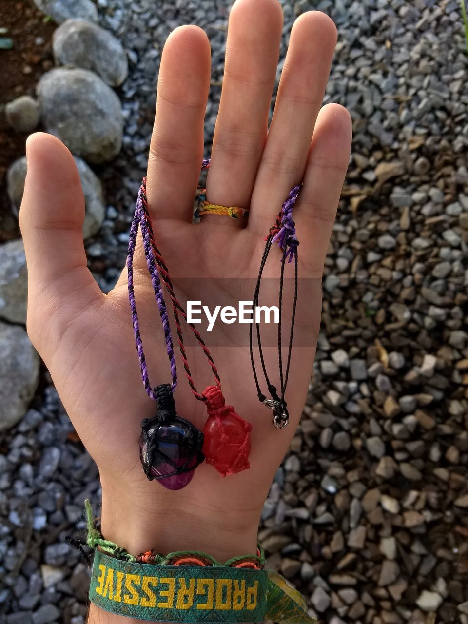 CLOSE-UP OF WOMAN HAND WITH ROCK