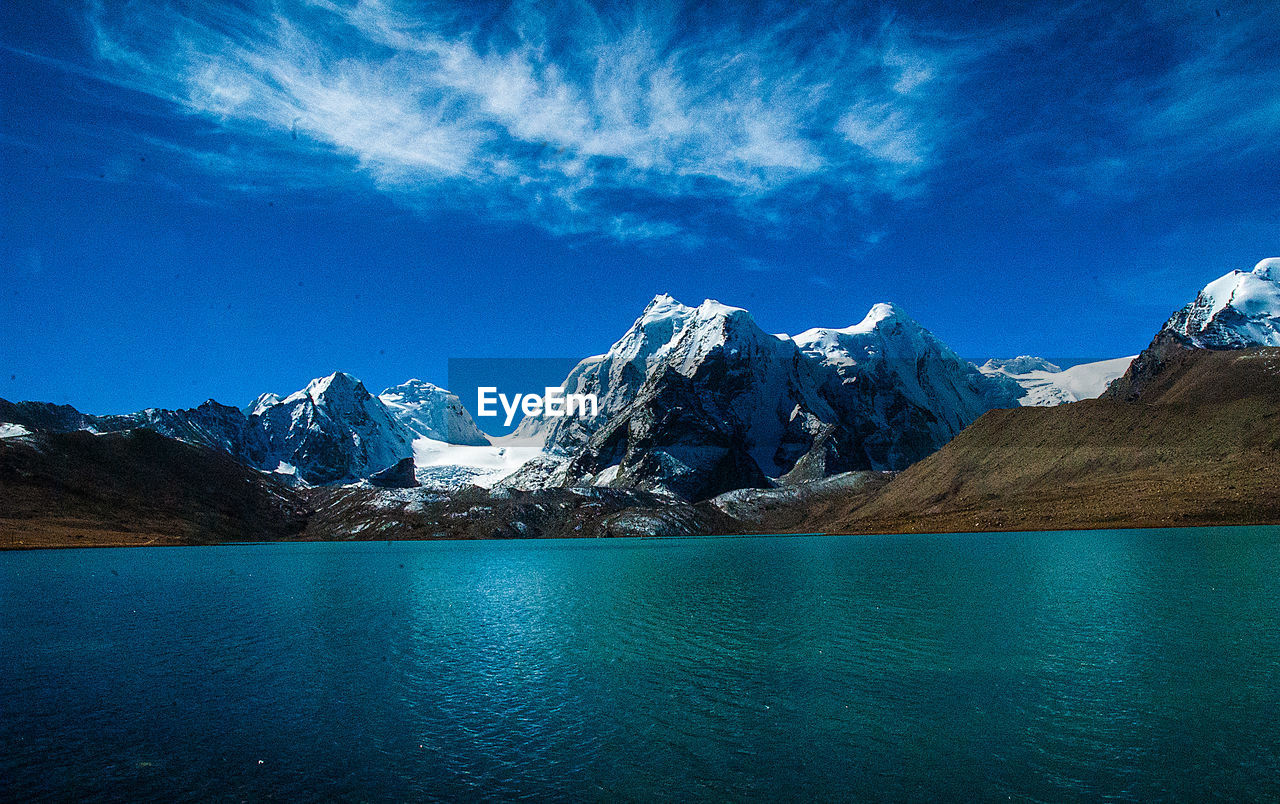 SCENIC VIEW OF SNOWCAPPED MOUNTAIN AGAINST BLUE SKY DURING WINTER