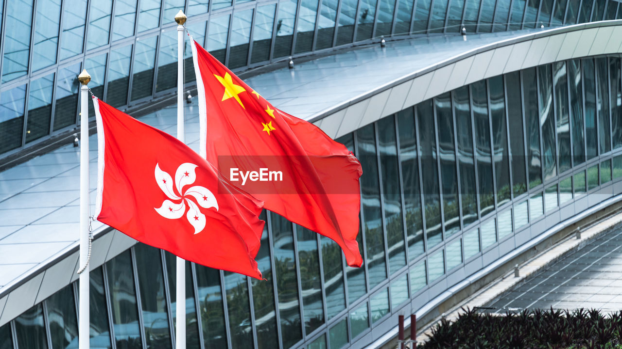 Flag against modern buildings in city